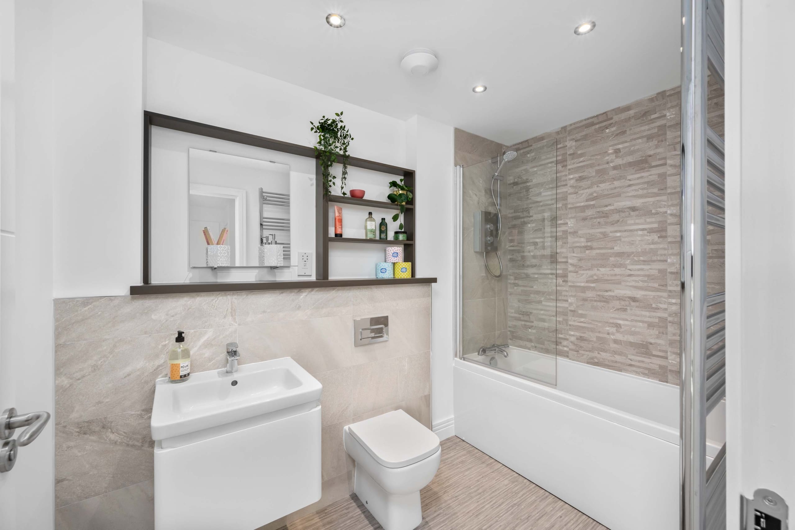 New build home in March Street, Peebles. Family bathroom with neutral tiling, white sanitary ware and chrome fittings