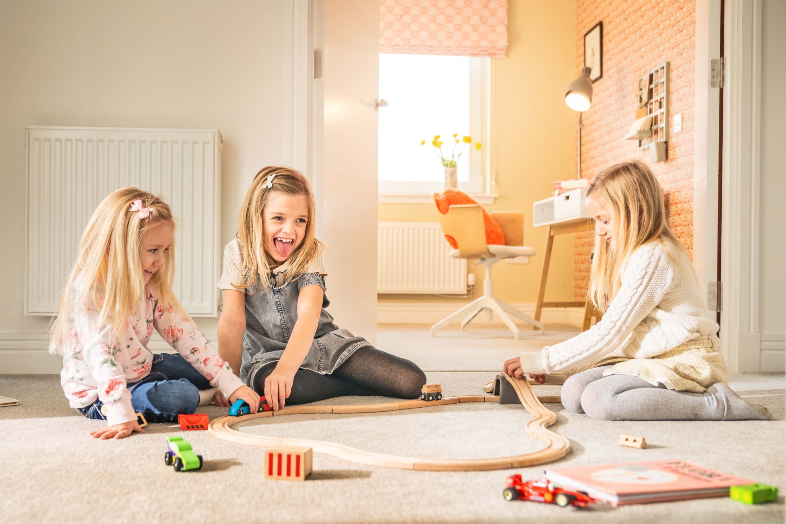 Children playing on the landing of a bright home. New build Scottish Borders