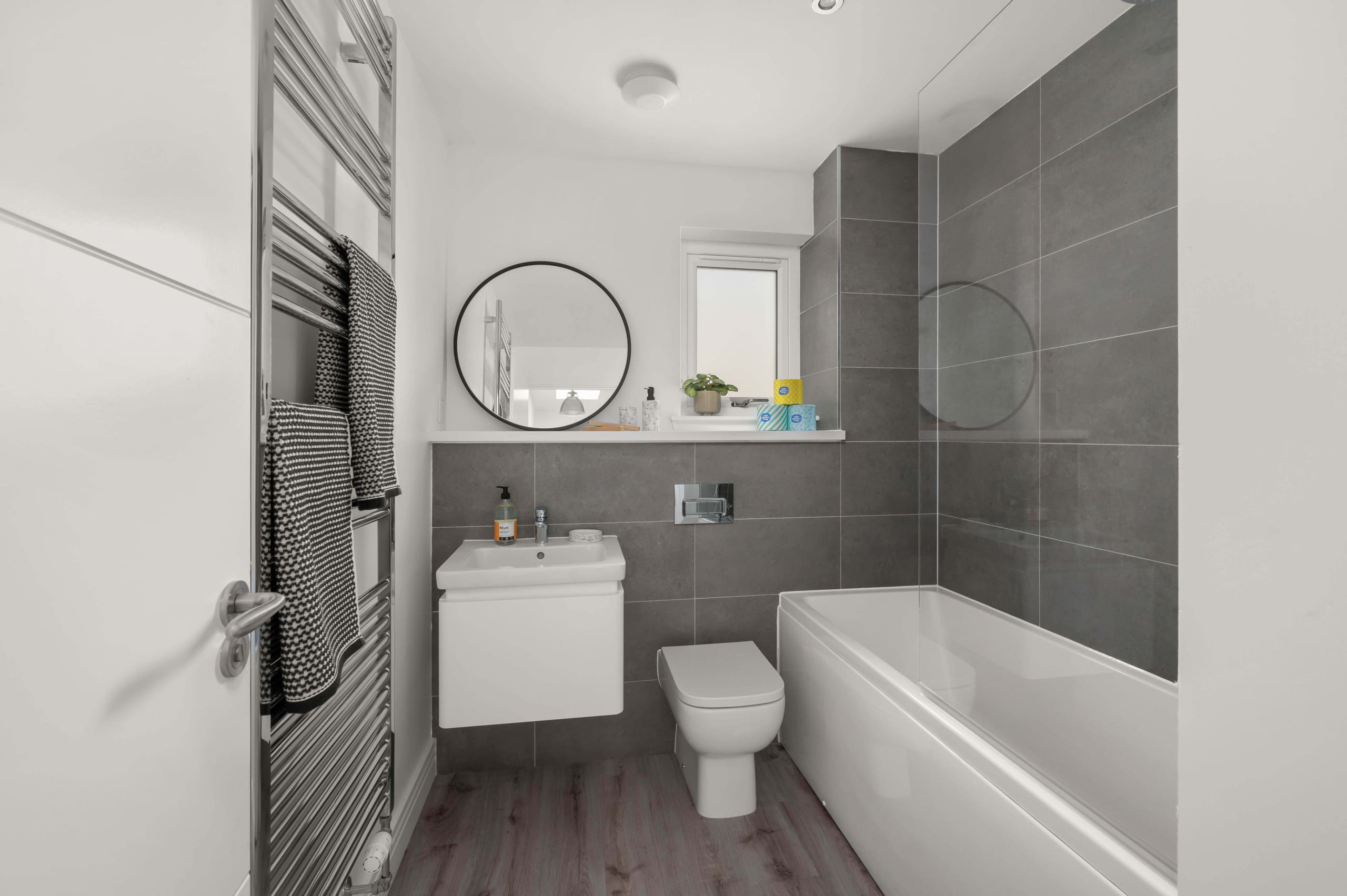 Fife, Kirkcaldy, Viewforth, New Build Homes. Modern bathroom with grey tiles, white sanitary ware and chrome fittings