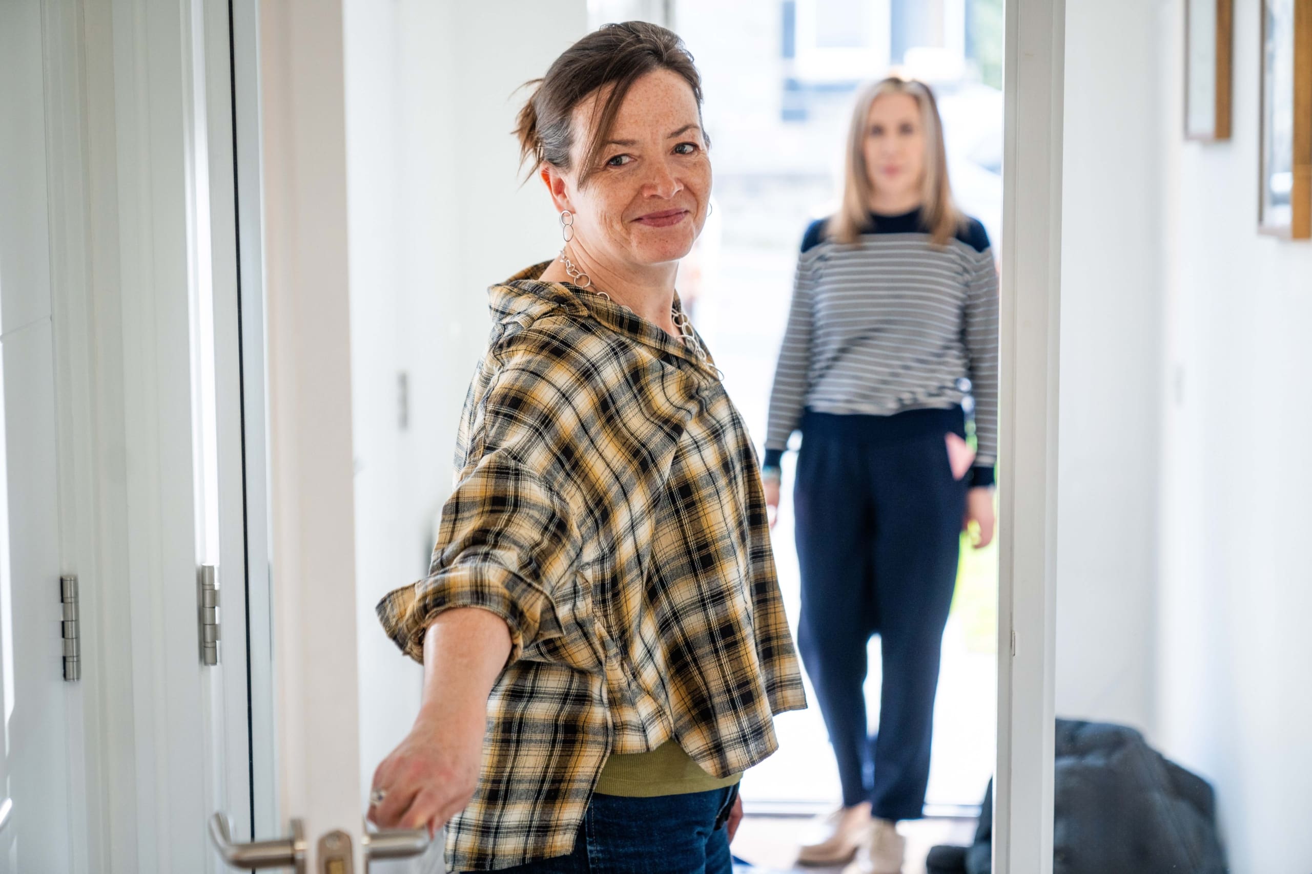 Viewforth, Kirkcaldy, Fife. Two women stepping through the front door of a new build house