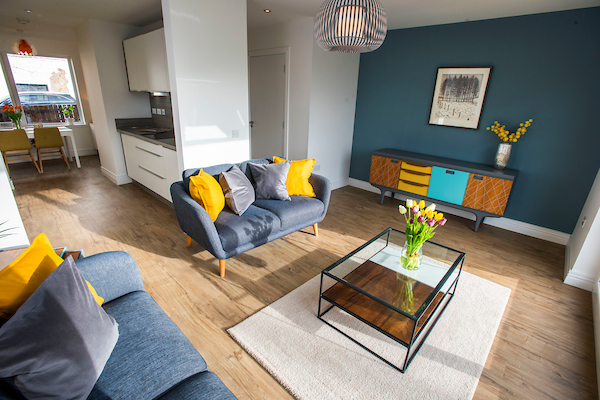 Colourful Living room with open plan space into kitchen/dining area and patio doors to garden of a new home, Lauder