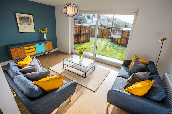 Allanbank, Lauder New Build Home. Colourful Living room with open plan spa\ce into kitchen/dining area and patio doors to garden